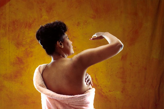 breast cancer diet_woman in white bath towel holding her hair